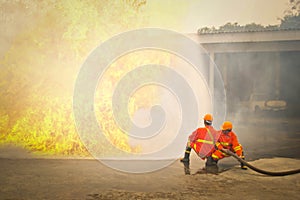 Firemen in action fighting fire during training