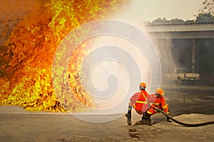 Firemen in action fighting fire during training