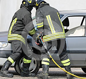 Firemen and a broken car on tafter the crash