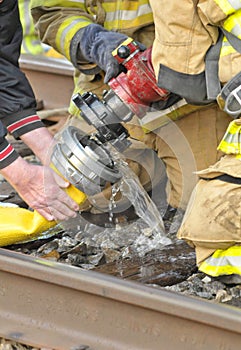 Firemen connect hose durbg train fire