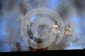 Firemen in Ladder Bucket Observing Fire