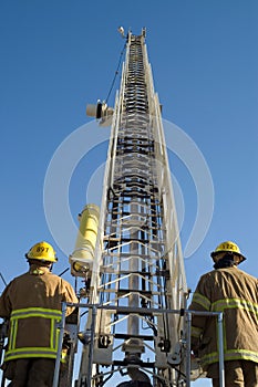 Firemen raise a ladder