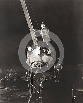 Firemen raising ladder on firetruck