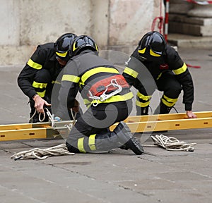 Firemen during rescue operations with a wooden ladder