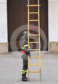 Firemen during rescue operations with a wooden ladder