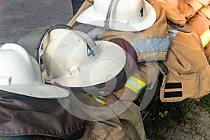 Firemen`s helmets clothing firefighters on the street