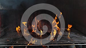 Fireplace barbecue is set on fire with firelighters and give large flames through the grill plate