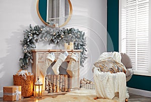 Fireplace with Christmas stockings in festive interior