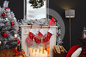 Fireplace with Christmas stockings in room interior