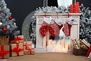 Fireplace with Christmas stockings in room interior