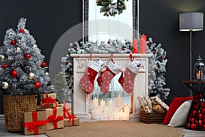 Fireplace with Christmas stockings in room interior