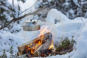 Fireplace and coffee pot in Finland. There is a sunset in the background.