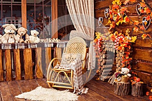 Fireplace collected from logs, rocking-chair and furs in the room