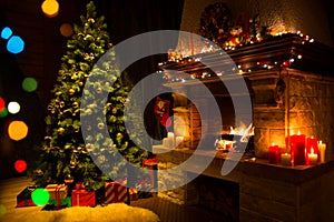 Fireplace and decorated Christmas tree and candles