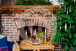 fireplace and house decorated with Christmas tree, garland, candles and wreath.