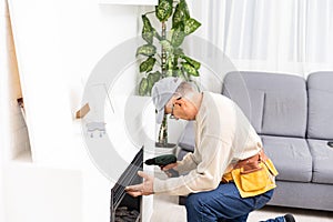 Fireplace installing in white brick wall.