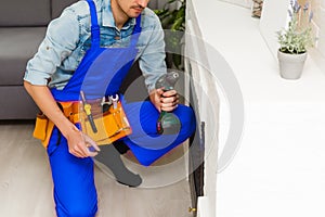 Fireplace installing in white brick wall.