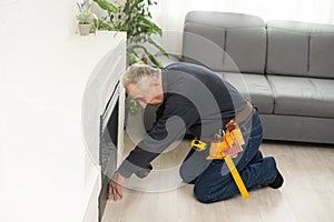 Fireplace installing in white brick wall.