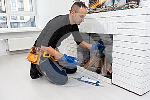 Fireplace installing in white brick wall.