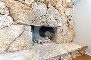 Fireplace interior with large stones surround and hearth