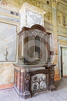 Fireplace in interior of old abandoned palace in Sharivka