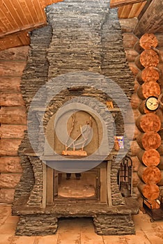Fireplace in the interior of a wooden house