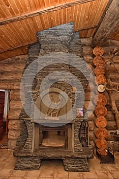 Fireplace in the interior of a wooden house