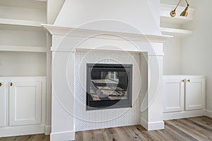 Fireplace with white tiles in herringbone pattern surround