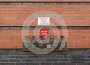 Firepump test headers on red brick wall