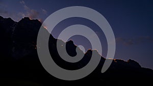 Fires of Johanni festival on the mountain peaks of Wilder Kaiser in Austria during July