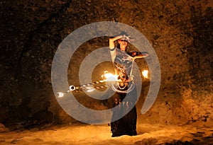 Fireshow artist dancing with fire ring