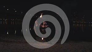 Fireshow artists performing dance with torches
