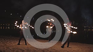 Fireshow artists turning around juggling fire outdoors