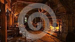 Fireside tables with food and drink in a medieval fantasy tavern. 3D rendering photo