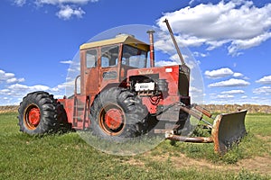 Versatile tractor with a blade