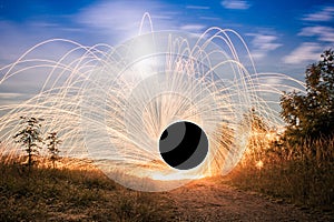 Firetrail of sparks flying through the air to create a vortex wormhole