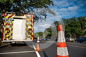 Firetuck and orange cone on roadside