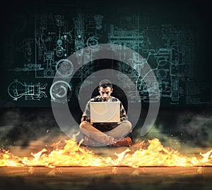 Firewall protection. Man working on laptop in front of a firewall.