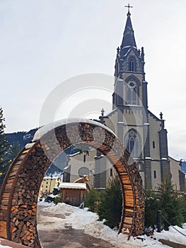 A firewood arch with church of Saints Philip and James