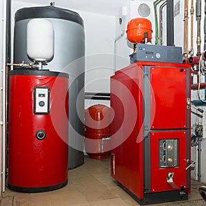 Firewood boiler and puffer thank in the boiler room