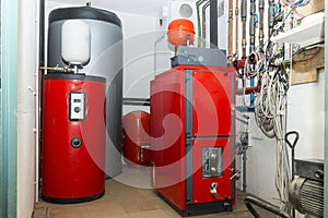 Firewood boiler and puffer thank in the boiler room