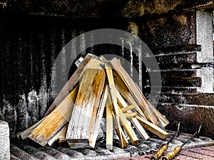 Firewood in a concrete grill piled up
