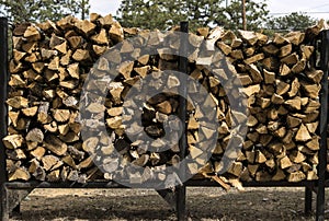 Firewood cut and stacked in racks for sale