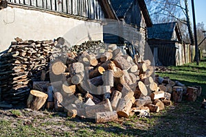 Firewood for furnace heating. Warehouse firewood for stove. Firewood stacked and prepared for winter Pile of wood logs