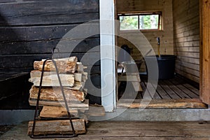 Firewood next to the open door to the traditional Finnish sauna