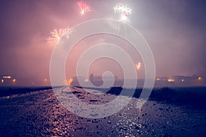 Firework concept for air pollution: New year firework on the sky, dirt wet road