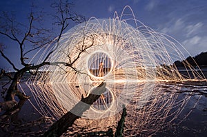 Firework and fire swing on dead tree fourground