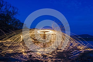 Firework and fire swing on dead tree fourground