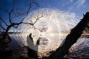 Firework and fire swing on dead tree fourground