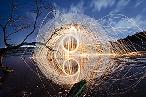 Firework and fire swing on dead tree fourground
